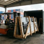 Marble and granite slabs in fumigated wooden bundles loading into 20ft container – natural stone export from Mundra port